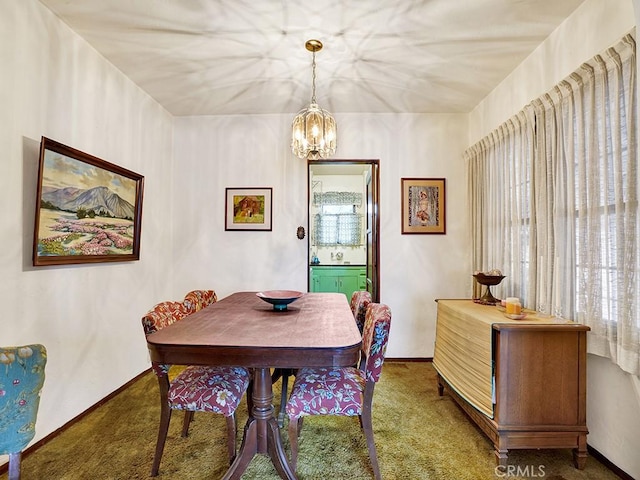 639 Magnolia Ave, Inglewood, CA 90301 - dining area featuring carpet flooring, a chandelier, and baseboards