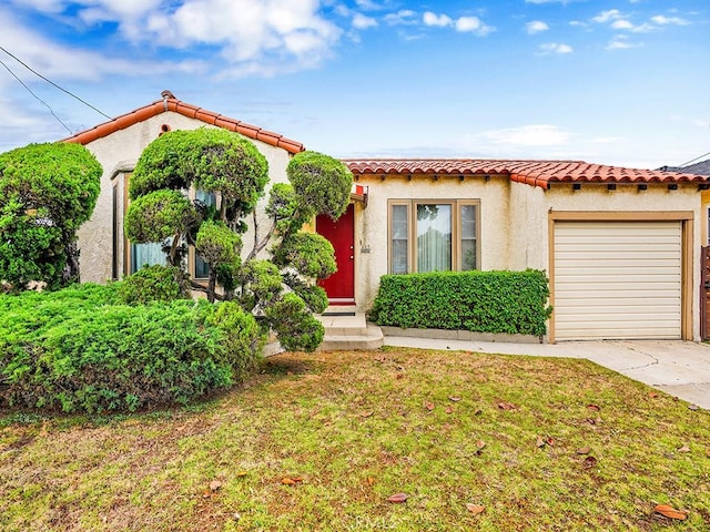 639 Magnolia Ave, Inglewood, CA 90301 - mediterranean / spanish home featuring concrete driveway, an attached garage, stucco siding, and a tile roof