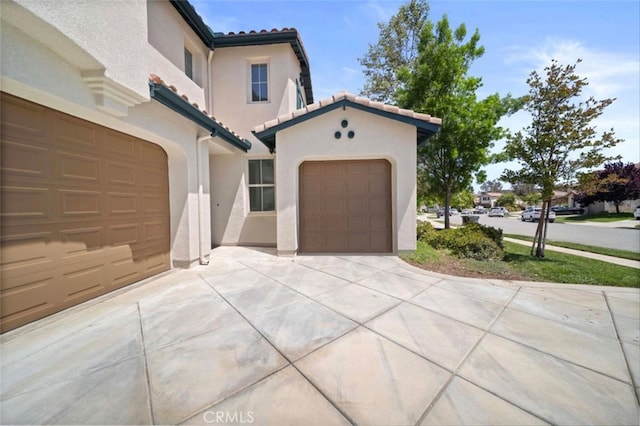 34090 Lady Fern Ct, Lake Elsinore, CA 92532 - view of front of property with concrete driveway, a tile roof, and stucco siding