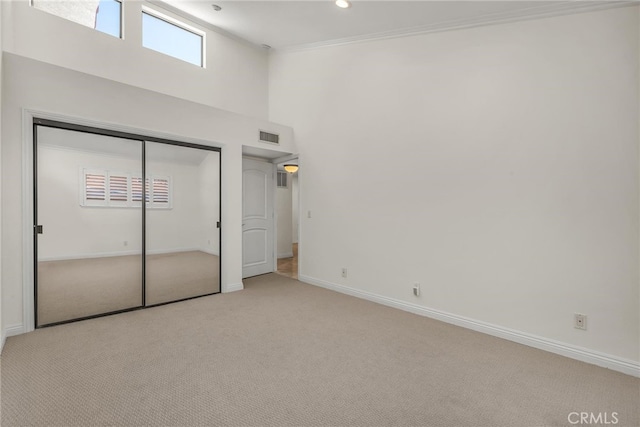 1205 S Catalina Ave S Unit A, Redondo Beach, CA 90277 - unfurnished bedroom with carpet flooring, a towering ceiling, baseboards, a closet, and multiple windows