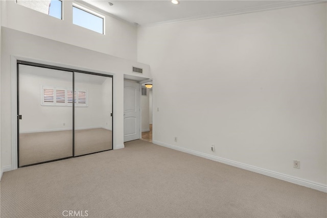 1205 S Catalina Ave S Unit A, Redondo Beach, CA 90277 - unfurnished bedroom with light colored carpet, a high ceiling, a closet, multiple windows, and ornamental molding