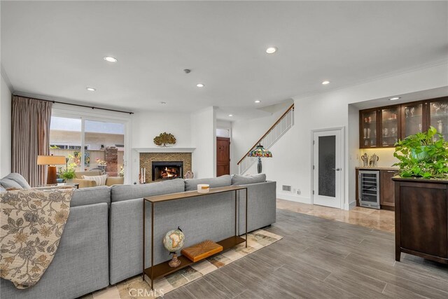 1205 S Catalina Ave S Unit A, Redondo Beach, CA 90277 - living area with wet bar, wine cooler, recessed lighting, a warm lit fireplace, and crown molding