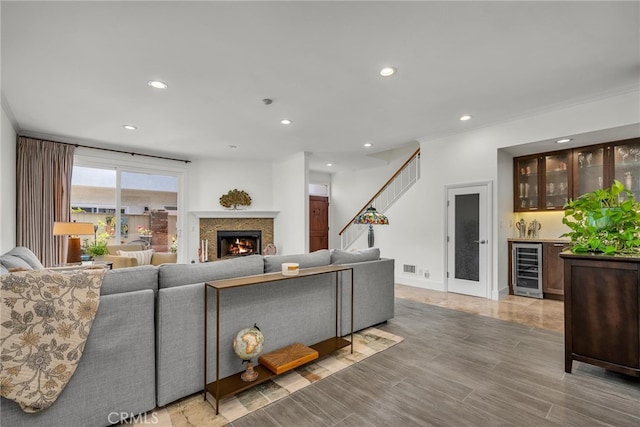1205 S Catalina Ave S Unit A, Redondo Beach, CA 90277 - living room with beverage cooler, bar with sink, recessed lighting, a lit fireplace, and crown molding