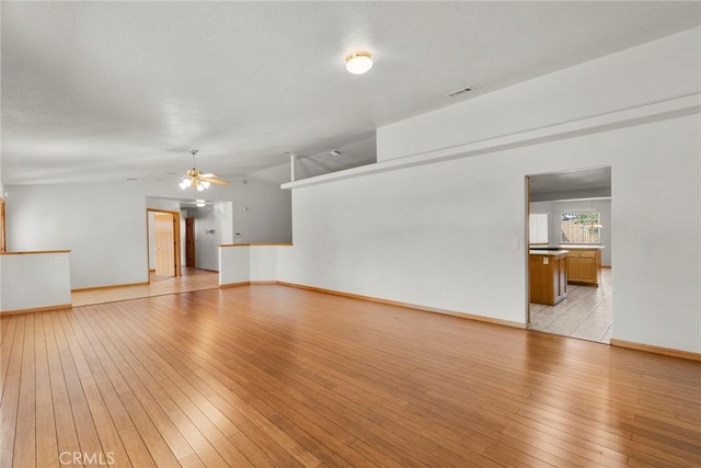 13209 Richmond Way, Apple Valley, CA 92308 - unfurnished living room featuring light wood-style flooring, a ceiling fan, and baseboards