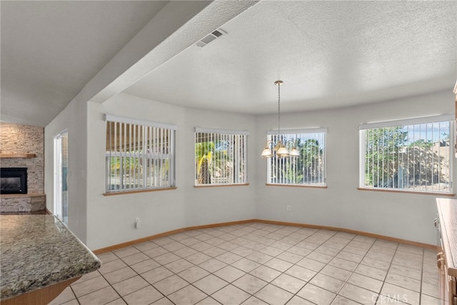 13209 Richmond Way, Apple Valley, CA 92308 - unfurnished dining area featuring light tile patterned floors, a chandelier, baseboards, and a fireplace