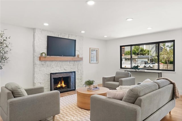 742 Hudson Ave, Costa Mesa, CA 92626 - living area with a stone fireplace, wood finished floors, recessed lighting, and baseboards
