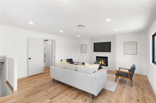 742 Hudson Ave, Costa Mesa, CA 92626 - living room featuring a large fireplace, recessed lighting, light wood-type flooring, and baseboards