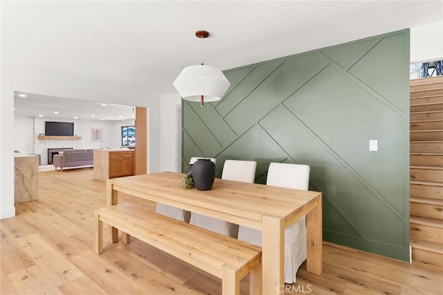 742 Hudson Ave, Costa Mesa, CA 92626 - dining area featuring light wood-style floors, stairway, plenty of natural light, recessed lighting, and a fireplace