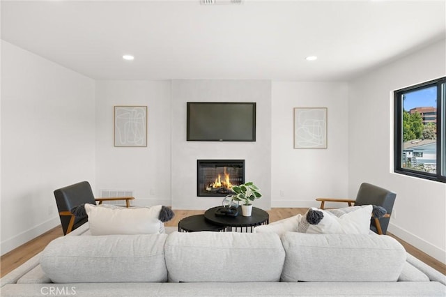 742 Hudson Ave, Costa Mesa, CA 92626 - living room with a glass covered fireplace, recessed lighting, baseboards, and wood finished floors
