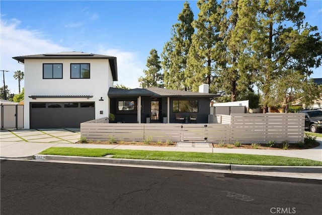 742 Hudson Ave, Costa Mesa, CA 92626 - view of front facade featuring solar panels, concrete driveway, an attached garage, a chimney, and a gate