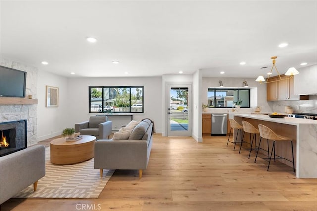 742 Hudson Ave, Costa Mesa, CA 92626 - living area with light wood-style flooring, recessed lighting, a fireplace, and baseboards