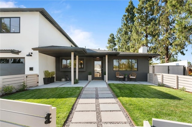 742 Hudson Ave, Costa Mesa, CA 92626 - rear view of property with stucco siding and a chimney