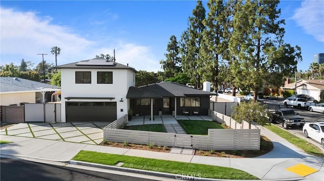 742 Hudson Ave, Costa Mesa, CA 92626 - view of front of property with a garage, a fenced front yard, solar panels, concrete driveway, and stucco siding
