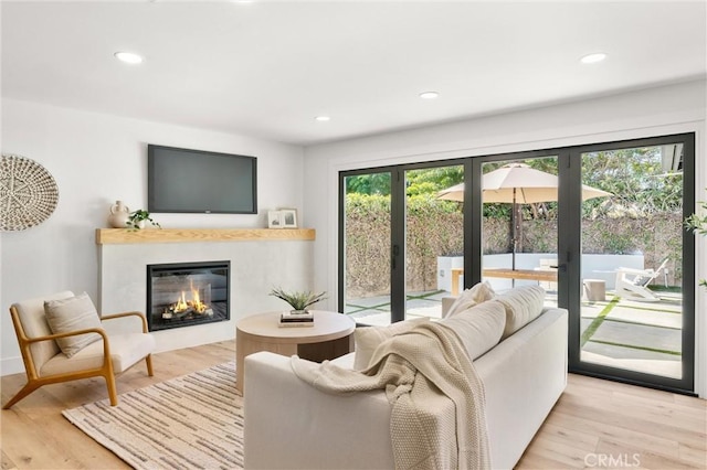 742 Hudson Ave, Costa Mesa, CA 92626 - living area featuring french doors, a glass covered fireplace, light wood-type flooring, and recessed lighting
