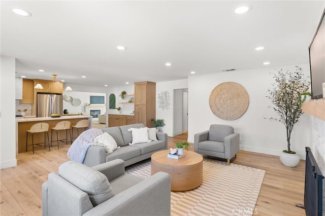 742 Hudson Ave, Costa Mesa, CA 92626 - living room featuring recessed lighting, light wood-type flooring, and baseboards
