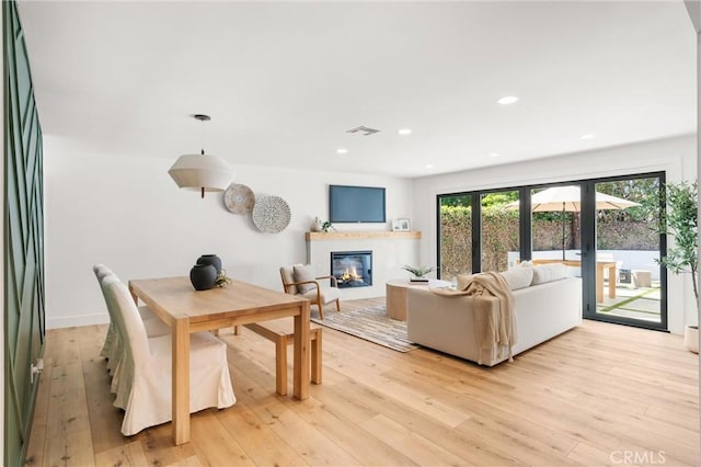 742 Hudson Ave, Costa Mesa, CA 92626 - living room featuring a glass covered fireplace, light wood-type flooring, and recessed lighting