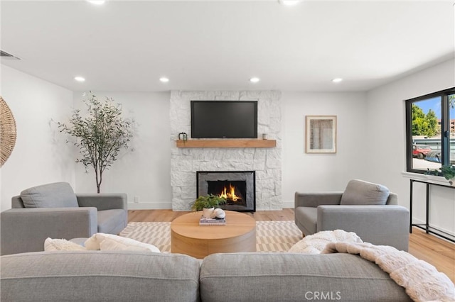 742 Hudson Ave, Costa Mesa, CA 92626 - living room with recessed lighting, a stone fireplace, wood finished floors, and baseboards