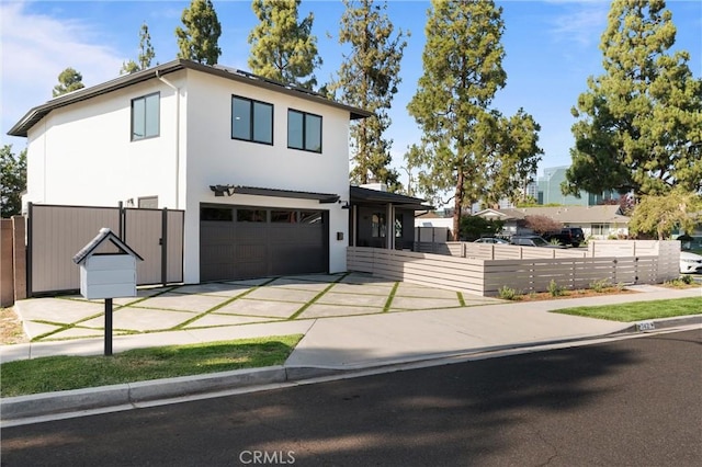 742 Hudson Ave, Costa Mesa, CA 92626 - view of front of home featuring concrete driveway, an attached garage, and stucco siding