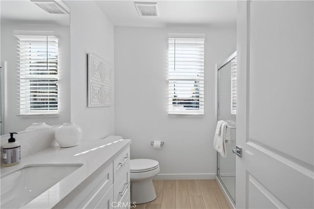 415 E 220th St, Carson, CA 90745 - full bathroom featuring double vanity, a stall shower, toilet, and wood finished floors
