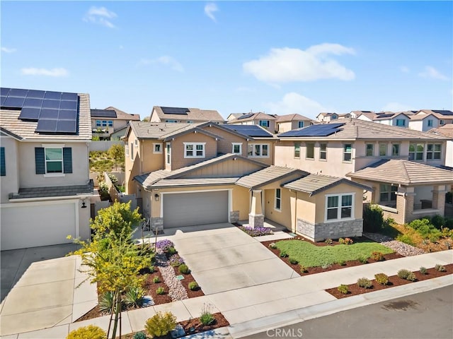 32172 Verbena Way, Temecula, CA 92591 - view of front of house featuring a residential view, stone siding, driveway, stucco siding, and roof mounted solar panels