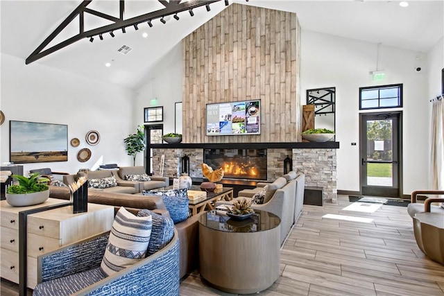 32172 Verbena Way, Temecula, CA 92591 - living room featuring high vaulted ceiling, a stone fireplace, and wood finished floors