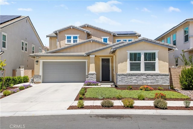 32172 Verbena Way, Temecula, CA 92591 - craftsman-style home with stone siding, a garage, driveway, and roof mounted solar panels