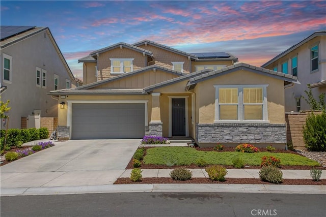 32172 Verbena Way, Temecula, CA 92591 - craftsman-style house featuring stone siding, driveway, an attached garage, and roof mounted solar panels