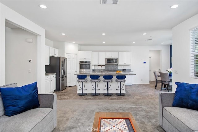 32172 Verbena Way, Temecula, CA 92591 - carpeted living room featuring recessed lighting, baseboards, and a sink