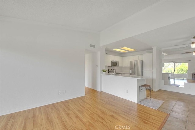 1995 Las Colinas Cir Unit 307, Corona, CA 92879 - unfurnished living room featuring a ceiling fan and crown molding