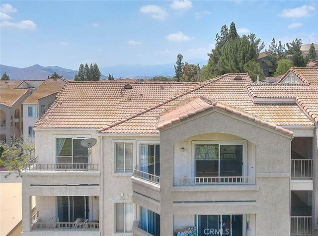 1995 Las Colinas Cir Unit 307, Corona, CA 92879 - back of property with stucco siding, a tile roof, a balcony, and a mountain view
