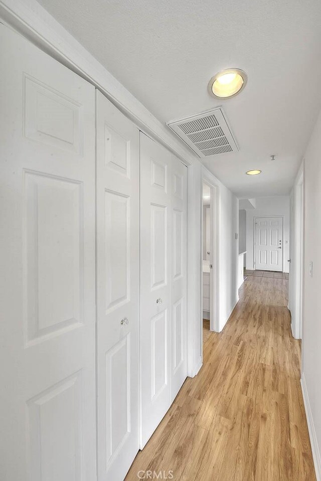 1995 Las Colinas Cir Unit 307, Corona, CA 92879 - corridor featuring light wood-style flooring and baseboards