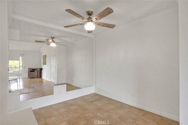1995 Las Colinas Cir Unit 307, Corona, CA 92879 - spare room with a textured ceiling, ceiling fan, ornamental molding, baseboards, and light tile patterned floors