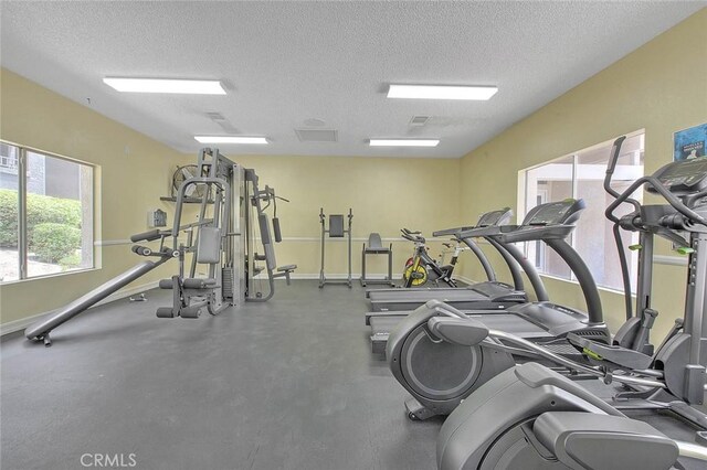 1995 Las Colinas Cir Unit 307, Corona, CA 92879 - workout area with a textured ceiling, healthy amount of natural light, and baseboards