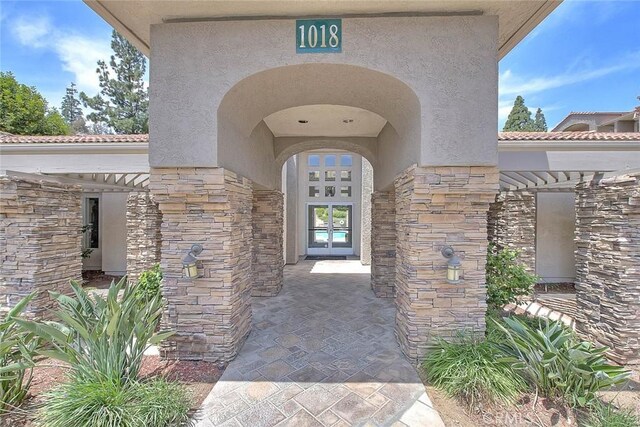 1995 Las Colinas Cir Unit 307, Corona, CA 92879 - doorway to property with stone siding, stucco siding, and a tiled roof