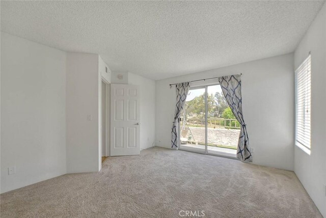 1995 Las Colinas Cir Unit 307, Corona, CA 92879 - empty room featuring carpet and a textured ceiling
