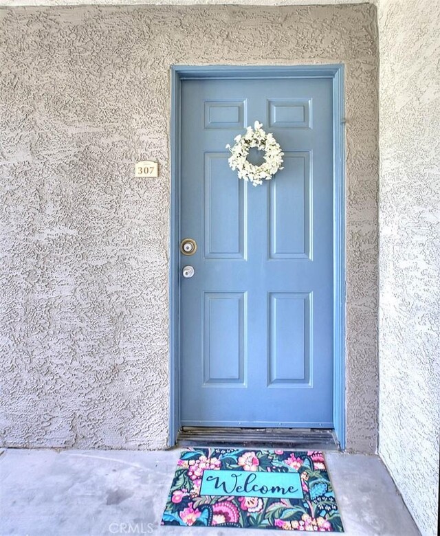1995 Las Colinas Cir Unit 307, Corona, CA 92879 - doorway to property with stucco siding