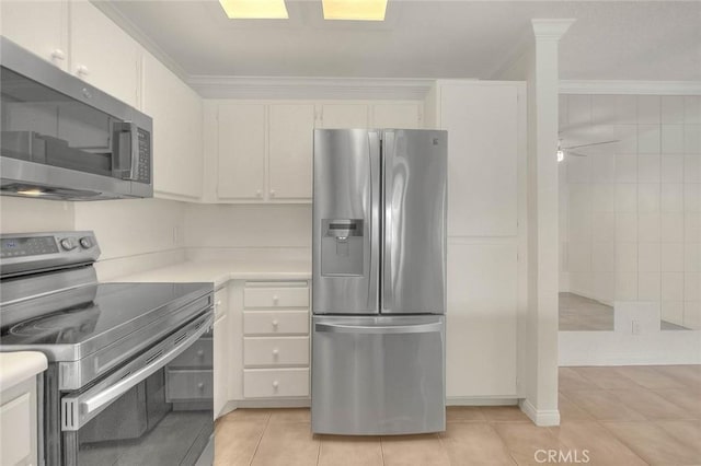 1995 Las Colinas Cir Unit 307, Corona, CA 92879 - kitchen with appliances with stainless steel finishes, light countertops, light tile patterned flooring, crown molding, and white cabinets