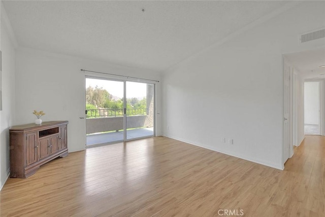 1995 Las Colinas Cir Unit 307, Corona, CA 92879 - unfurnished living room featuring light wood-style flooring, lofted ceiling, and baseboards