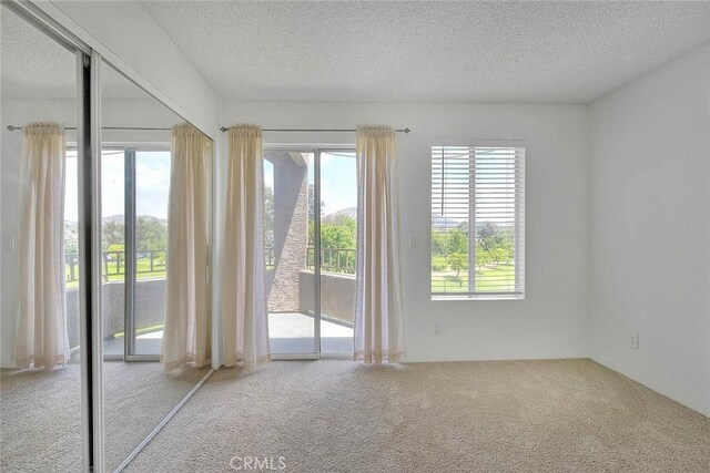 1995 Las Colinas Cir Unit 307, Corona, CA 92879 - empty room with carpet flooring and a textured ceiling