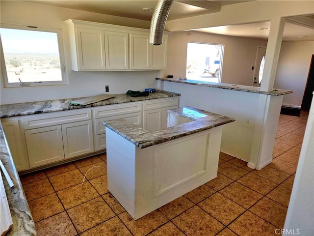 195 Old El Mirage Rd, Adelanto, CA 92301 - kitchen featuring white cabinetry, light tile patterned flooring, and a peninsula