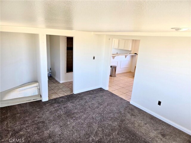195 Old El Mirage Rd, Adelanto, CA 92301 - empty room featuring light tile patterned floors, light carpet, baseboards, and a textured ceiling