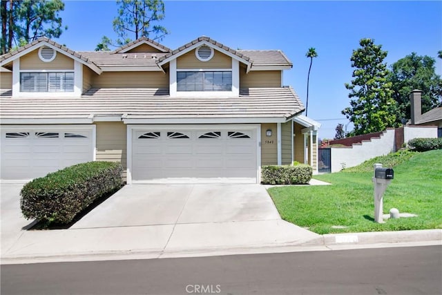 5840 Fairlane Dr, Riverside, CA 92506 - traditional-style house with a tiled roof, a garage, a front yard, and driveway