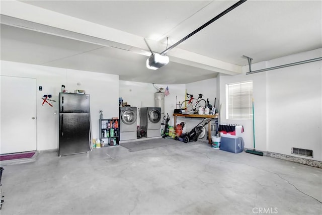 5840 Fairlane Dr, Riverside, CA 92506 - garage featuring freestanding refrigerator, washer and clothes dryer, and a garage door opener