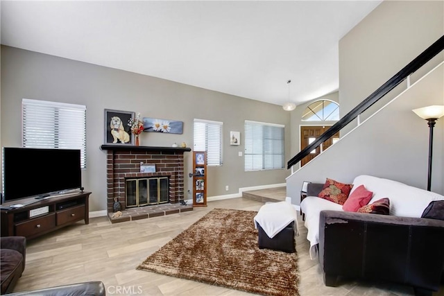 5840 Fairlane Dr, Riverside, CA 92506 - living area with stairs, wood finished floors, baseboards, and a fireplace