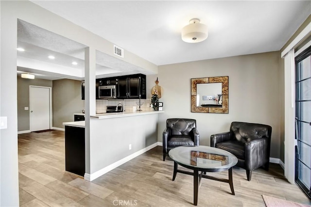 5840 Fairlane Dr, Riverside, CA 92506 - sitting room featuring recessed lighting, light wood-style floors, and baseboards