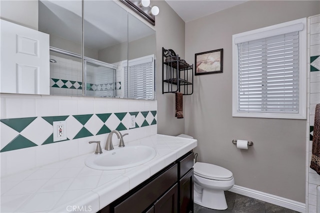 14522 San Feliciano Ln, Mirada, CA 90638 - full bathroom featuring backsplash, vanity, a stall shower, toilet, and baseboards