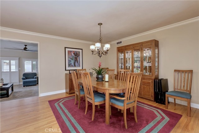 14522 San Feliciano Ln, Mirada, CA 90638 - dining room featuring a chandelier, light wood-style floors, ornamental molding, baseboards, and a ceiling fan