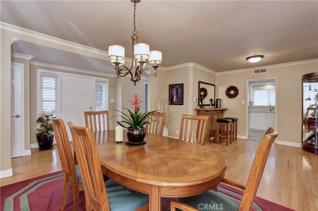 14522 San Feliciano Ln, Mirada, CA 90638 - dining area featuring a chandelier, light wood finished floors, baseboards, and ornamental molding