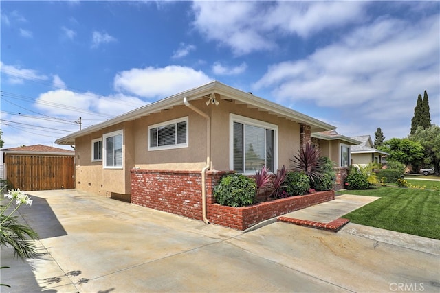 14522 San Feliciano Ln, Mirada, CA 90638 - view of home's exterior featuring stucco siding, a patio area, and concrete driveway