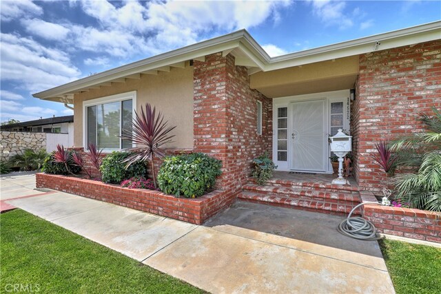 14522 San Feliciano Ln, Mirada, CA 90638 - doorway to property with brick siding and stucco siding